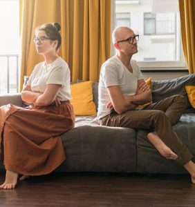 man and woman sitting on couch